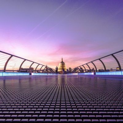 London footbridge at dusk with St Paul's Cathedral in the distance